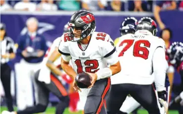  ?? AP FILE PHOTO/JUSTIN REX ?? Tampa Bay Buccaneers quarterbac­k Tom Brady (12) hands off the ball during the first half of a preseason game against the Houston Texans in Houston.