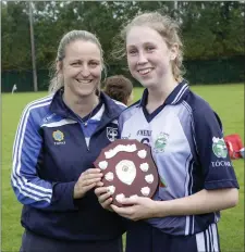  ??  ?? Maura Reid presents the shield to An Tochar captain Hannah Kelly.