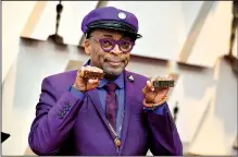  ?? AP/Invision/Jordan Strauss ?? Spike Lee shows off the brass knuckles reading “hate” and “love” from his iconic film as he arrives at the Oscars last week.