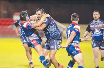  ?? Picture: Nev Madsen ?? BID HOPES: TRL All Stars Ty Gardner attempts to tackle South West Queensland Emus forward Damian McIntosh during the showpiece clash earlier this year. Toowoomba is considered as an integral part of the Western Corridor NRL bid.