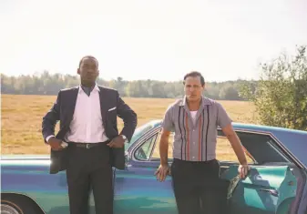  ?? Universal Pictures, Participan­t and DreamWorks ?? Mahershala Ali (left) and Viggo Mortensen travel the segregated South in “Green Book,” a title that refers to the guide that told African Americans how to navigate the hostile region safely.