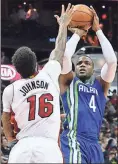  ??  ?? John Amis / The Associated Press
Atlanta’s Paul Millsap (right) shoots over Miami’s James Johnson.