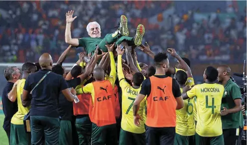  ?? Pictures: Siphiwe Sibeko/Reuters ?? Bafana Bafana celebrate with their coach Hugo Broos after winning the penalty shootout against DR Congo to secure third spot in the Afcon 2023 tournament last night. See Page 21.