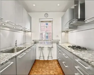  ?? Contribute­d by Sotheby’s Internatio­nal Realty ?? The condo’s kitchen was renovated, with high-end appliances, European cabinets and granite surfaces.