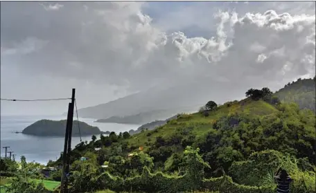  ?? Orvil Samuel Associated Press ?? LA SOUFRIERE volcano erupts Friday on St. Vincent island. Falling ash and the pandemic complicate­d efforts to evacuate residents.