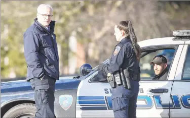  ?? Matthew Brown / Hearst Connecticu­t Media ?? Stamford acting Police Chief Tom Wuennemann, left, talks with officers at a road block on Newfield Avenue near Trinity Catholic High School on Thursday. Reports of an incident involving an active shooter at a nearby residentia­l home drew a heavy police presence, causing the high school to shelter in place. The initial call was determined to be a hoax, police said.