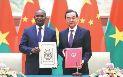  ?? FENG YONGBIN/ CHINA DAILY ?? State Councilor and Foreign Minister Wang Yi and Burkina Faso’s Foreign Minister Alpha Barry have signed a joint statement in Beijing on Saturday resuming the countries’ diplomatic relations. Wang said the government of Burkina Faso made the right...