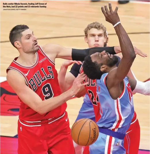  ?? JONATHAN DANIEL/GETTY IMAGES ?? Bulls center Nikola Vucevic, fouling Jeff Green of the Nets, had 22 points and 13 rebounds Sunday.