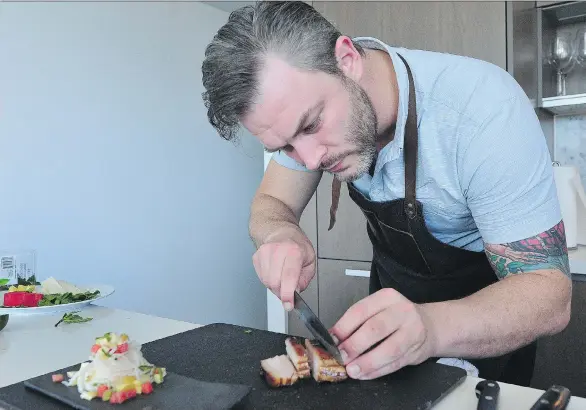  ?? NICK PROCAYLO ?? Chef Travis Petersen cooks in his Vancouver kitchen. Petersen is the chef for Dinner in the Sky, the buzzy aerial food experience that is taking place next month.