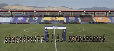  ?? RICK BOWMER - ASSOCIATED PRESS ?? Players for the Portland Thorns, left, and the North Carolina Courage kneel during the national anthem before the start of their NWSL Challenge Cup soccer match at Zions Bank Stadium on Saturday in Herriman, Utah.