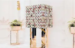  ?? BOCA DO LOBO ?? The Pixel bar cabinet is clad in over a thousand multicolor­ed triangles made of woods like palisander and African walnut, evoking a pixelated image.