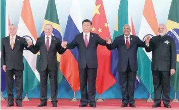  ?? — AFP ?? (L to R) Brazil’s President Michel Temer, Russia’s President Vladimir Putin, China’s President Xi Jinping, South Africa’s President Jacob Zuma and India’s Prime Minister Narendra Modi pose for a group photo during the BRICS Summit in Xiamen on Monday.