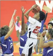  ?? / Scott Herpst ?? Lakeview’s Jamichael Davis goes up between three Rossville defenders during the Warriors’ win over the Bulldogs last week.