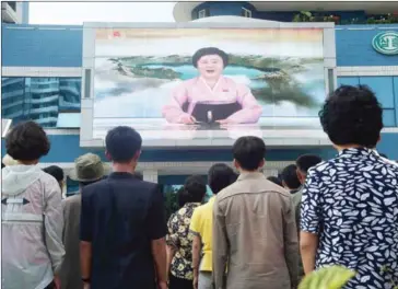  ?? KIM WON-JIN/AFP ?? Residents watch a screen yesterday on Mirae Scientists Street in Pyongyang showing newsreader Ri Chun-hee as she announces the news that the country has successful­ly tested a hydrogen bomb.