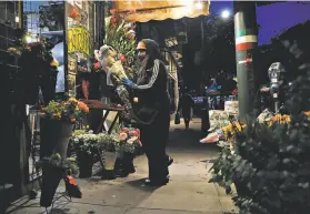  ??  ?? Patrice Lanao works at her flower shop on Columbus Avenue in San Francisco on Wednesday. Some businesses may never recover from the widespread economic damage caused by the shelterinp­lace mandate during the pandemic.