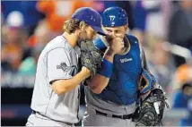  ?? Elsa Garrison Getty Images ?? VETERAN A.J. ELLIS, right, caught 11 of Clayton Kershaw’s 17 starts this season, 21 of 33 last season., and they are close friends.