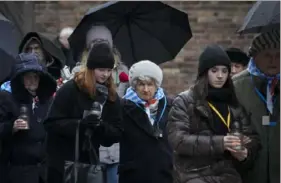  ?? Czarek Sokolowski/Associated Press ?? Holocaust survivors and relatives arrive Saturday at the Auschwitz Nazi death camp in Oswiecim, Poland. Survivors of Nazi death camps marked the 79th anniversar­y of the liberation of the Auschwitz-Birkenau camp during World War II in a modest ceremony in southern Poland.