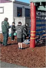  ??  ?? The four intermedia­te cadets are assessing and talking to two patients who fell off the log ladder.