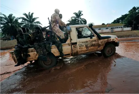  ?? — AFP photo by Sia Kambou ?? A file photo taken on March 28, 2013 Seleka rebels patrol in a street of Bangui.