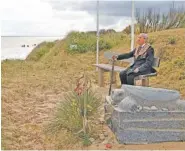  ?? AP PHOTO/VIRGINIA MAYO ?? World War II D-Day veteran and Penobscot Elder from Maine, Charles Norman Shay sits on a bench next to his memorial stone at Omaha Beach prior to a ceremony in Saint-Laurent-sur-Mer, Normandy, France, on Friday.