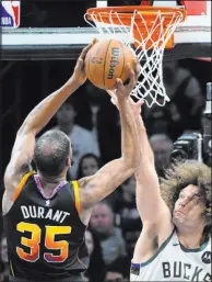  ?? Ross D. Franklin The Associated Press ?? Phoenix Suns forward Kevin Durant goes up for a basket and gets fouled by Milwaukee Bucks center Robin Lopez.