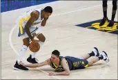  ?? DARRON CUMMINGS — THE ASSOCIATED PRESS ?? The Indiana Pacers’ T.J. McConnell (9) dives for a loose ball against the Golden State Warriors’ Kent Bazemore during the first half Wednesday in Indianapol­is.