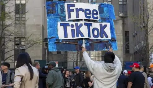  ?? ?? A man carries a Free TikTok sign in front of the courthouse where the hush-money trial of Donald Trump got underway April 15, 2024, in New York.