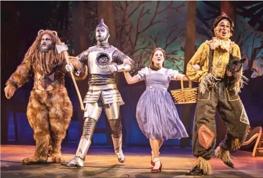  ?? LIZ LAUREN ?? Paul-Jordan Jansen plays Cowardly Lion, Carl Draper is Tin Man, Elizabeth Stenholt plays Dorothy and Kyle Adams is Scarecrow (with Nessa as Toto) in Paramount Theatre’s “The Wizard of Oz.”