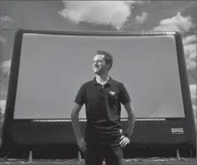  ?? MATHEW MCCARTHY, RECORD STAFF ?? Jacob Tutt stands in front of his inflatable movie screen in Waterloo. He runs Fresh Air Films.