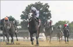  ?? SETH WENIG ?? FILE - In this June 20, 2020, file photo, Tiz the Law, center, with jockey Manny Franco up, crosses the finish line to win the 152nd running of the Belmont Stakes horse race at Belmont Park in Elmont, N.Y.