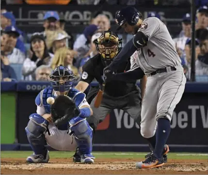  ?? MARK J. TERRILL, THE ASSOCIATED PRESS ?? Astros’ George Springer hits a home run against the Dodgers in the third inning of Game 6 of Major League Baseball’s World Series on Tuesday night in Los Angeles, giving Houston a 1-0 lead in the contest. The Astros entered the contest up 3-2 in the...