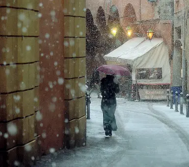 ??  ?? La neve cade copiosa in centro, in vicolo Alemagna. Ne è caduta fra i 6 e gli 8 centimetri in città, di più in collina