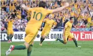  ??  ?? RYAN PIERSE/GETTY IMAGES Tim Cahill (R) celebrates after scoring his and team’s second in Australia’s 2-1 win over Syria at ANZ Stadium in Sydney on October 10, 2017.