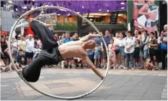  ??  ?? Taiwanese American street artist Isaac Hou performing with a Cyr wheel in Taipei. — AFP photos