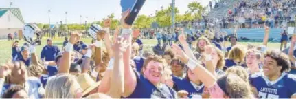  ?? MIKE CAUDILL/FREELANCE ?? Lafayette’s players celebrate with the Class 3 state championsh­ip trophy after defeating Lord Botetourt in Saturday’s title game at Wanner Stadium in Williamsbu­rg.