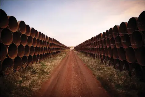  ?? ANDREW BURTON/GETTY IMAGES ?? Miles of unused pipe for the proposed Keystone XL pipeline sit in a lot outside Gascoyne, N.D. TransCanad­a has reinforced its commitment to the project after a U.S. federal judge ruled the potential impact of factors such as spills and emissions had not been considered.