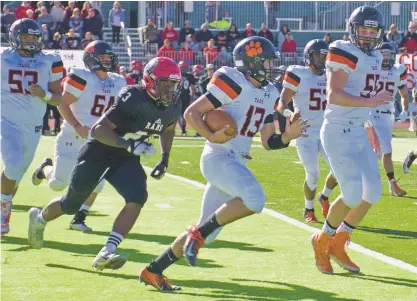  ?? SHEILA MILLER/TAOS NEWS ?? Taos quarterbac­k Justin Good, pursued by the Rams Romeo Gassagee, scrambles for a first down Saturday in Portales in the Class 4A semifinals. Taos won, 35-14, and is in next weekend’s title game.