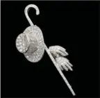  ?? HANCOCKS VIA NYT ?? Hancocks, the antique jewelry dealer in London, recently listed this 1930s diamond stick pin of a top hat and cane, which several women have reportedly expressed interest in buying. Jewelry on the catwalks has been as genderless as the fashion recently...