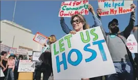  ?? Allen J. Schaben Los Angeles Times ?? AIRBNB supporters rally outside Santa Monica City Hall before a City Council vote in 2015. The city is among many that cracked down on short-term rentals.