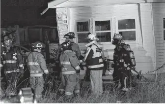  ?? ADRIAN JOHNSTONE ?? Brooklyn, Windsor and Hantsport firefighte­rs survey the damage after a fire quickly ripped through a travel trailer situated near this mobile home.