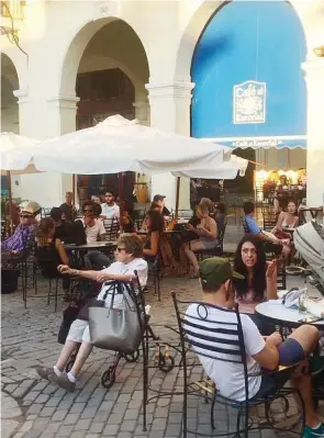  ?? Miami Herald file ?? Visitors crowd Havana’s Plaza de Armas in January. During the first four months of 2017, Cuba received 2 million internatio­nal travelers.