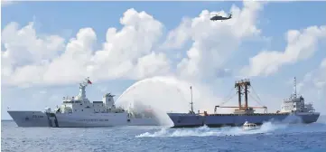  ??  ?? A Taiwan Coast Guard ship (left) extinguish­es a fire on a cargo ship during a rescue drill near the coast of Itu Aba, which the Taiwanese call Taiping, at the South China Sea. — Reuter photo