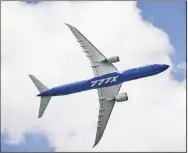  ?? (Bloomberg/Lauryn Ishak) ?? A Boeing 777X aircraft performs maneuvers during the Singapore Airshow held at the Changi Exhibition Centre in Singapore, on Feb. 15.