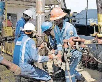  ?? | Reuters ?? WORKERS at an oil exploratio­n site in Bulisa district, 244km north-west of Kampala, Uganda. The East African Crude Oil Pipeline is a 1 443km crude-oil pipeline that will run from Uganda’s oil reserves in Hoima to Chongolean­i on Tanzania’s coast for the purpose of export.