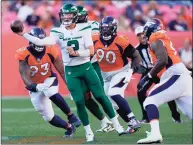  ?? David Zalubowski / Associated Press ?? Jets quarterbac­k Zach Wilson throws under pressure against the Broncos during the second half on Sunday in Denver. The Broncos won 26-0.