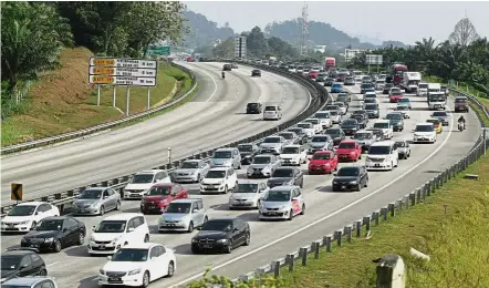  ??  ?? Bumper to bumper: Heavy traffic seen on the PLUS highway yesterday.