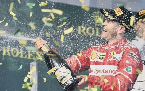  ??  ?? Sebastian Vettel celebrates his season-opening win for Ferrari in F1’s Australian Grand Prix in Melbourne yesterday