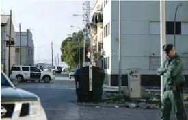  ??  ?? ROQUETAS DE MAR: Members of the Spanish Civil Guard patrol a street yesterday where a man from Guinea-Bissau was found dead, in Roquetas de Mar, near Almeria. — AFP