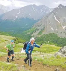  ?? Charlie Nuttelman, Special to The Denver Post ?? With assistant John Prater trailing, Andrew Hamilton hikes up Mount Elbert in July 2015, when he set a record by climbing all 58 of Colorado’s fourteener­s in under 10 days. Despite the feat, Hamilton says he does sometimes retreat before summiting,...