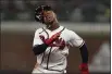  ?? BRYNN ANDERSON — THE ASSOCIATED PRESS ?? Braves Ozzie Albies loses his helmet as he runs to score on a single by Austin Riley in the eighth inning in Game 2 of baseball’s National League Championsh­ip Series Sunday in Atlanta.